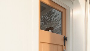 A wooden door with a glass panel and a metal handle. - Cupola - Ocean views of Lennox head. Above award winning restaurant, Shelter. (Lennox Head)