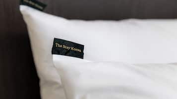 A pillow with a tag that reads 'The Stay Korea.'
