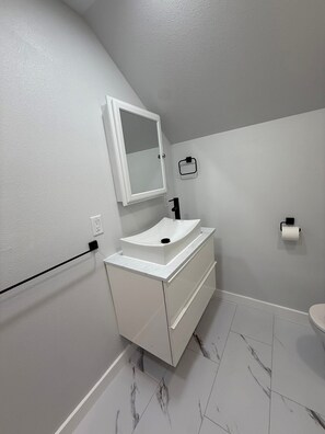 Regadera, secadora de cabello, toallas, papel de baño 