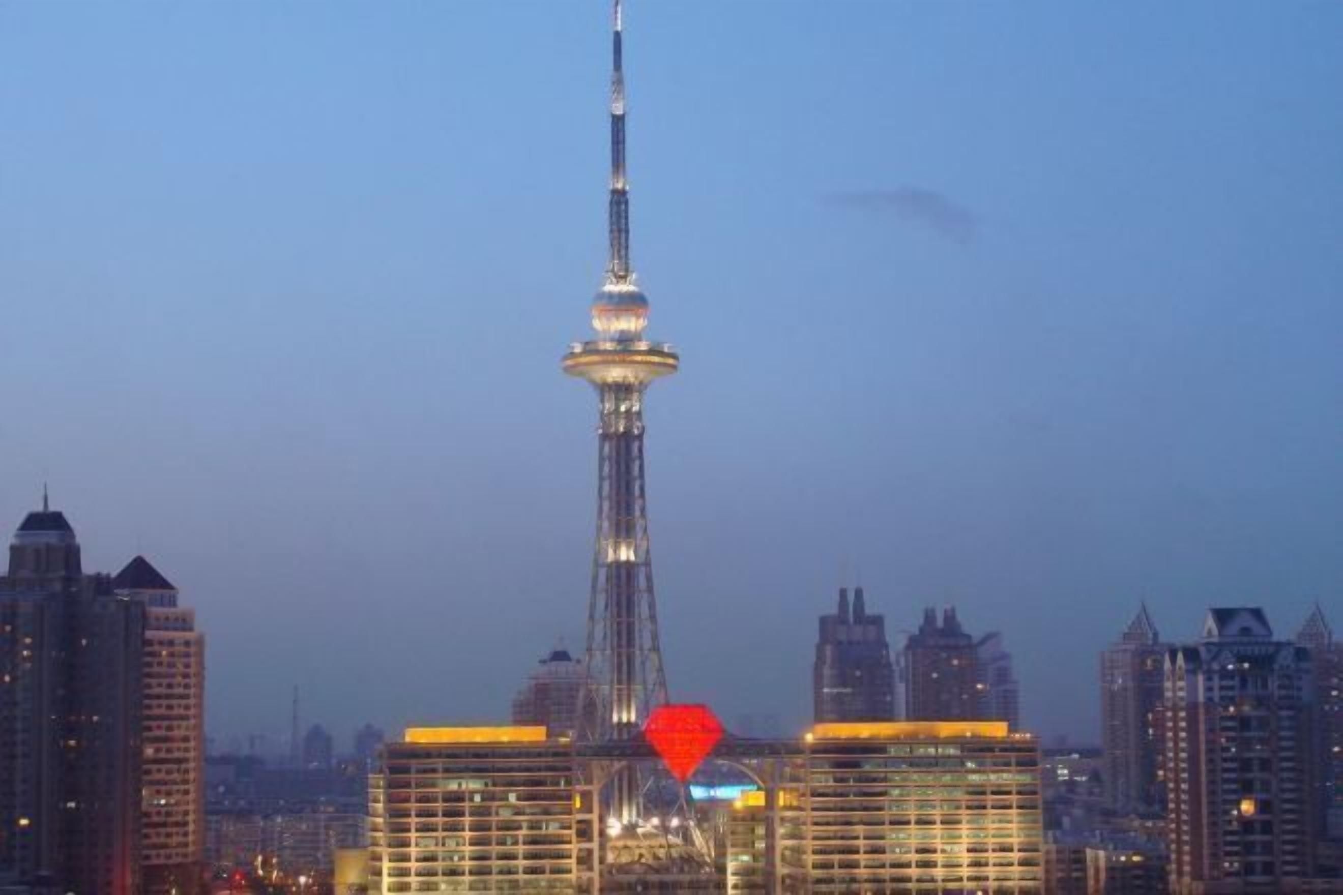 A cityscape with a prominent tower and surrounding high-rise buildings.