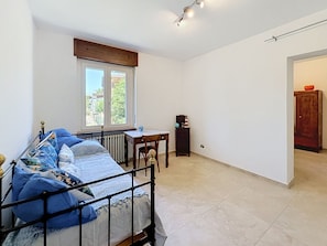 A bedroom with a bed, a window, a radiator, a desk, and a cabinet. - La casetta di Palmira by Interhome (San Damiano d'Asti)