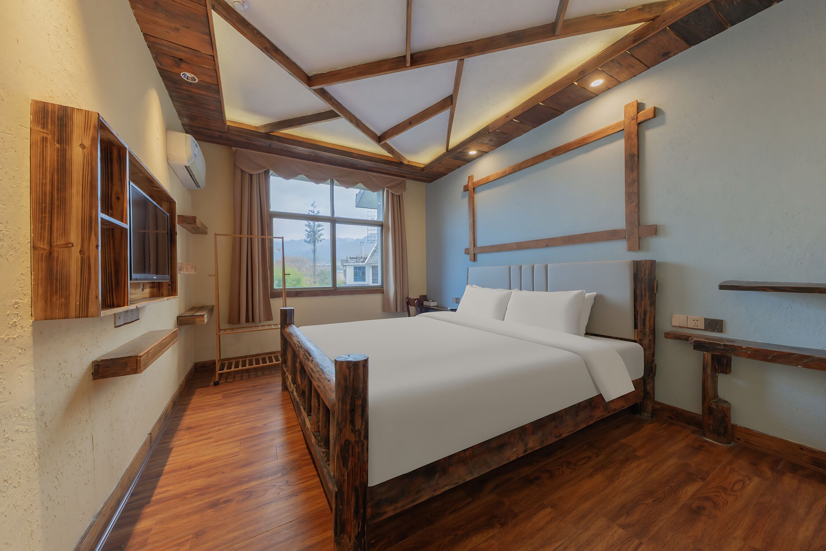 A bedroom with a wooden bed frame, a large window, and built-in shelves.