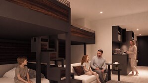 A modern living room with a sofa, a coffee table, and a built-in kitchen area. - VAYS TOKYO STATION EAST (Tokyo)