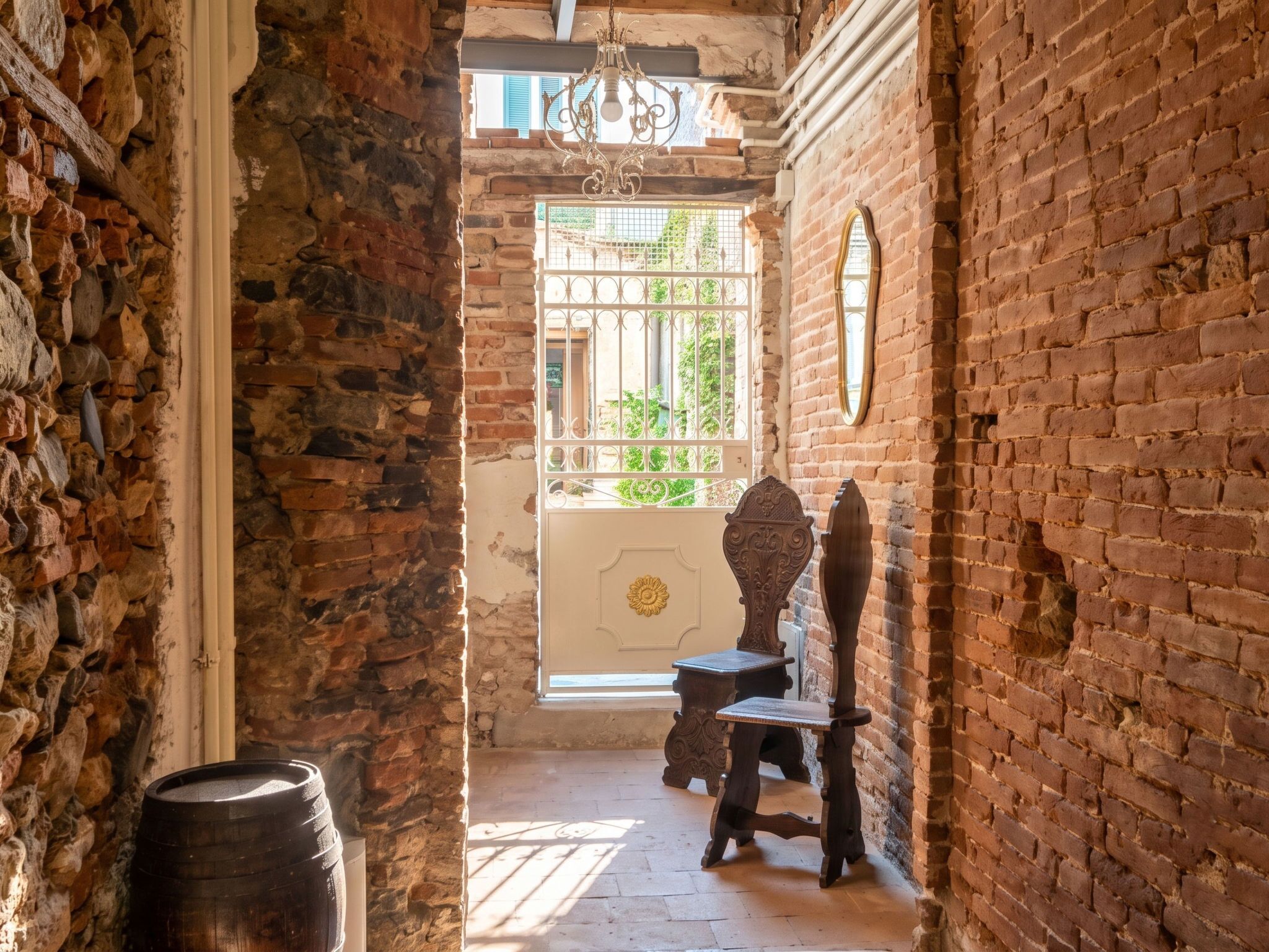 A narrow passageway with stone walls, a wooden barrel, and a rustic wooden chair.
