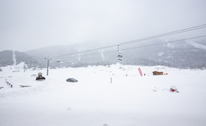 A snowy mountain scene with a ski lift, a wooden cabin, and a snow-covered landscape. - Apartment With Balcony for 6 People (Val-Cenis)