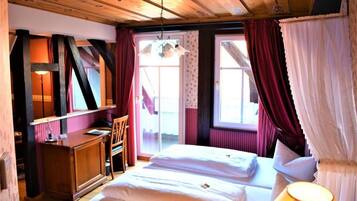 A room with a bed, a desk, and a chair.
