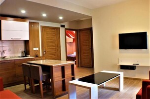 Presidential Apartment, Lake View | Living area | 42-inch TV with satellite channels