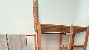 A wooden shelving unit with a hanging rack and a towel. - Central, Spacious Jawalakhel Hideaway on Quiet Residential Alley. (Lalitpur)