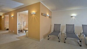 A waiting area with a reception desk, a glass door entrance, and three metal chairs. - Family Chalet Near Wildkogel Ski Slopes with Sauna (Neukirchen am Grossvenediger)
