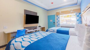 A hotel room with two beds, a TV, a desk, and a window with curtains.