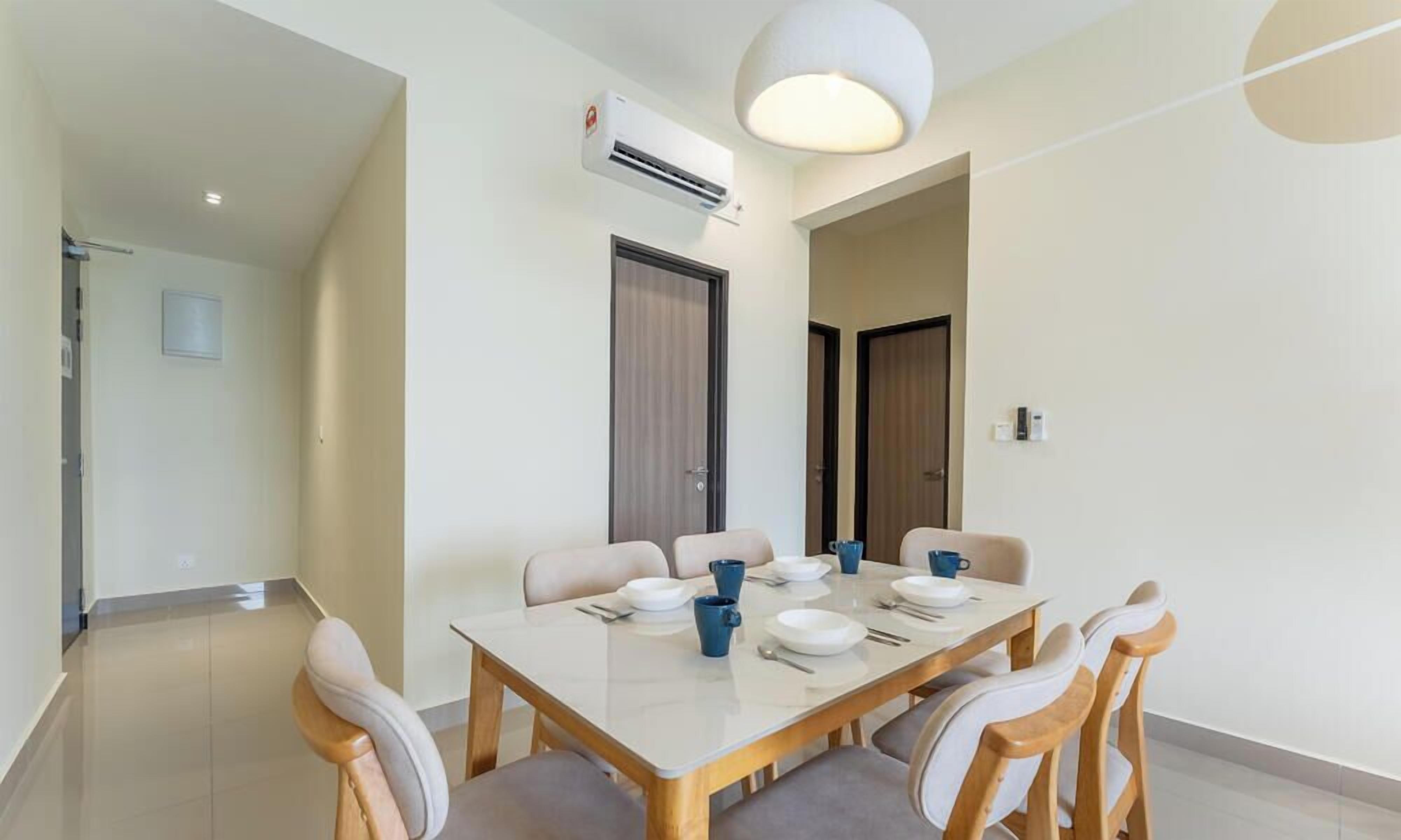 A dining area with a table set for four, chairs, an air conditioning unit, and a door.