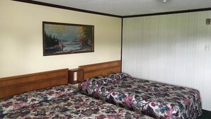 A room with two beds, a painting on the wall, and a ceiling light fixture. - 2 Full Beds Non-Smoking (Wathena, KS)