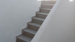 Una escalera con barandilla blanca que lleva a una plataforma.