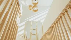 A staircase with wooden railings and a ceiling with circular light fixtures. - Hotel Orjen Sport&Pleasure (Trebinje)