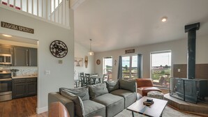 A spacious living area with a sectional sofa, a dining table, and a fireplace. - Lake + Mountain Views! Pagosa Springs Getaway (Pagosa Springs)