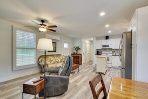 A modern kitchen with white cabinets, a stainless steel refrigerator, and a microwave. - 6 Mi to Three Sisters Springs! Extended Getaway (Homosassa)