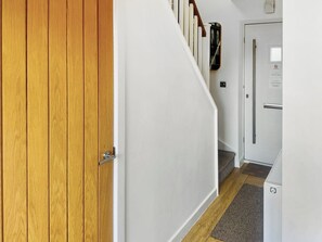 A wooden door, white walls, a staircase, and a white door with a handle. - The Salt Yard Villa 3 - UK52113 (Whitstable)