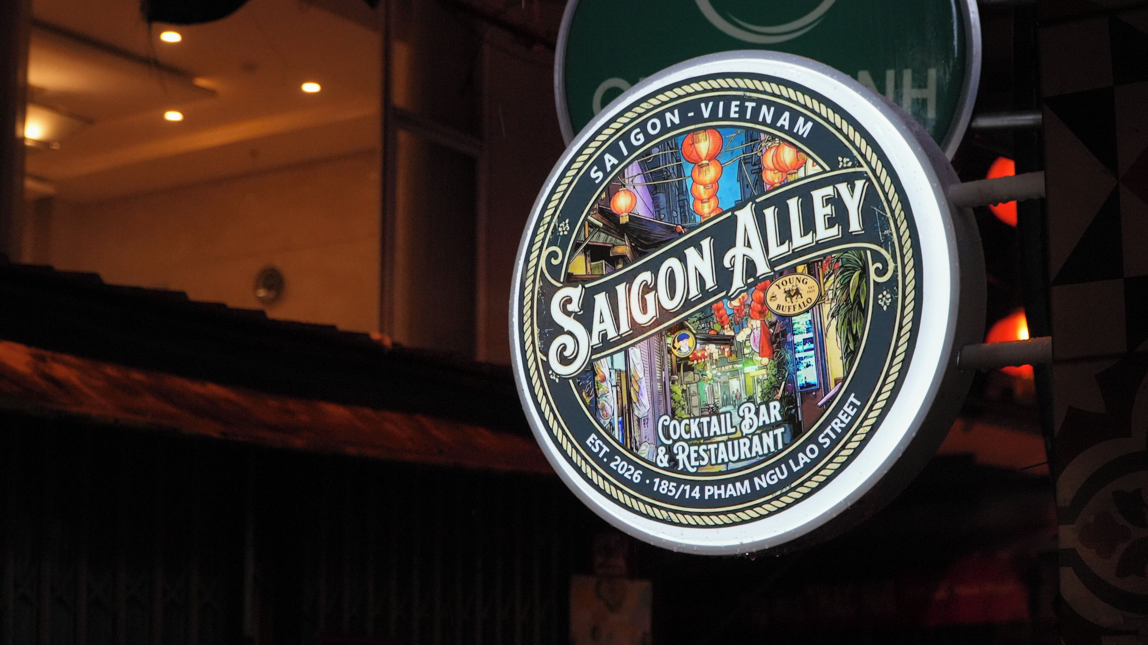 A sign for Saigon Alley, a cocktail bar and restaurant, with a vintage design and a neon sign.