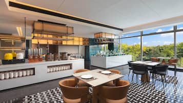 A modern kitchen with a central island, equipped with various appliances and utensils.