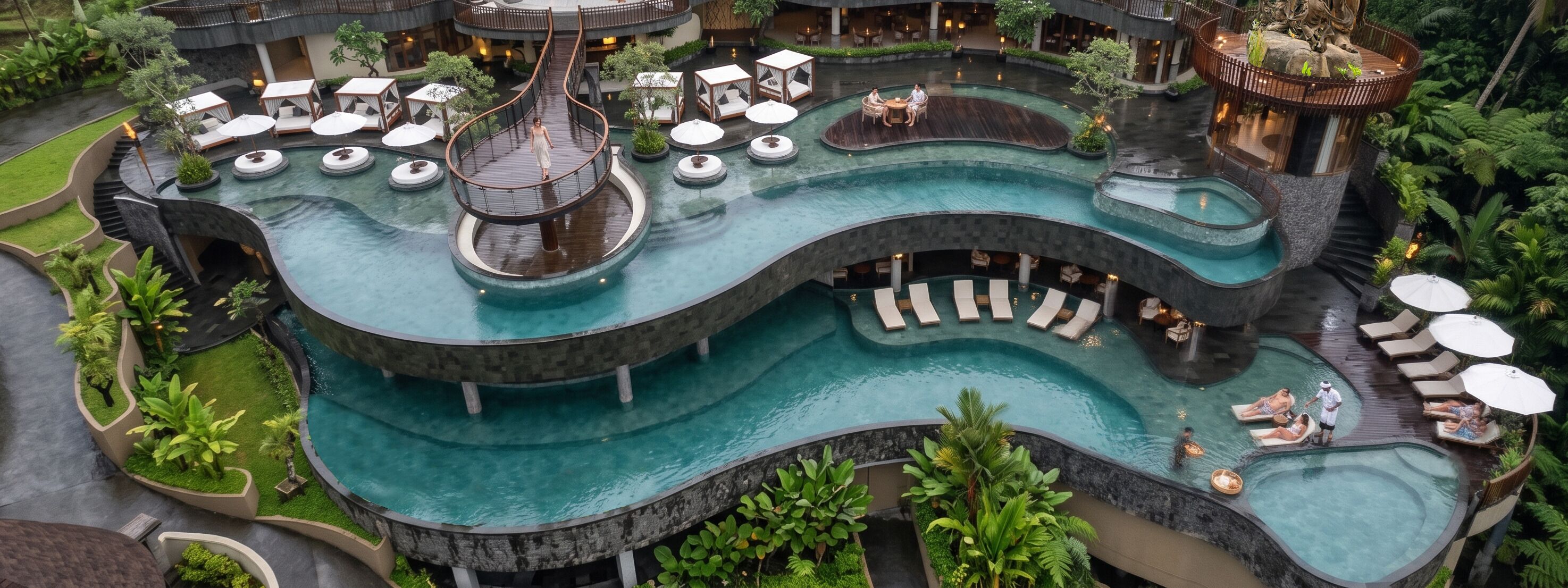 A multi-level pool area with various seating arrangements and a central water feature.