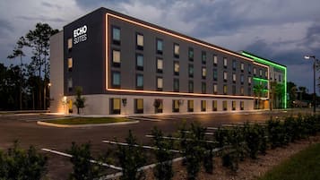 Um edifício de hotel moderno com uma placa na entrada que diz 'ECHO SUITES'.
