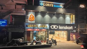 A hotel named 'Lord's Residency' with a sign for 'Lenskart' across the street. - Hotel Silvora Inn - Bhopal (Bhopal)