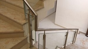 A staircase with glass railings and beige steps. - Hotel Silvora Inn - Bhopal (Bhopal)
