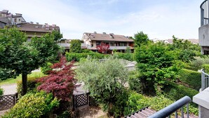Un quartier résidentiel avec des maisons, un jardin où l’on trouve différentes espèces de plantes et un escalier.