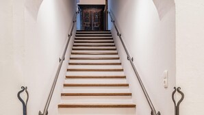 A staircase with wooden steps and metal handrails, leading to a dark wooden door at the top. - Chalet in Piesendorf Near Kaprun Near Skiresort (Angerberg)