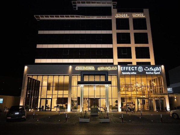 A hotel with a modern facade, large glass windows, and signage for 'Jadeel Hotel' and 'Effect Coffee.' - Jadeel Hotel (Al Khobar)