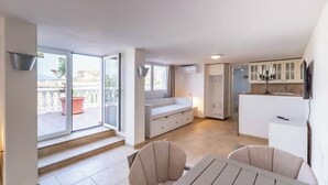 A modern apartment with a balcony, a dining area, and a kitchen. - 143 - Spacious Villa with Private Pool & Stunning Views (Fuengirola)