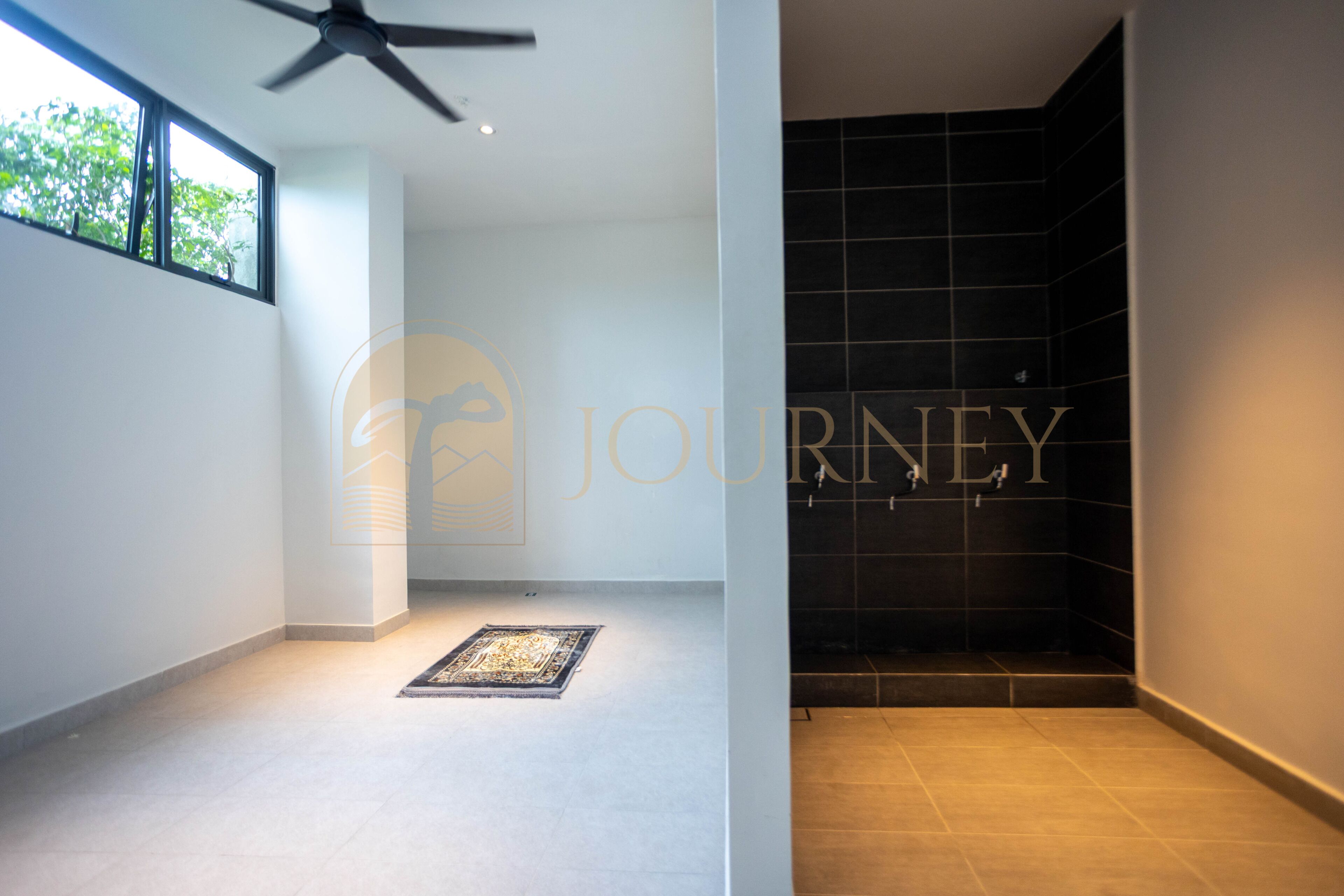 A modern interior with a large window, a ceiling fan, and a tiled shower area.