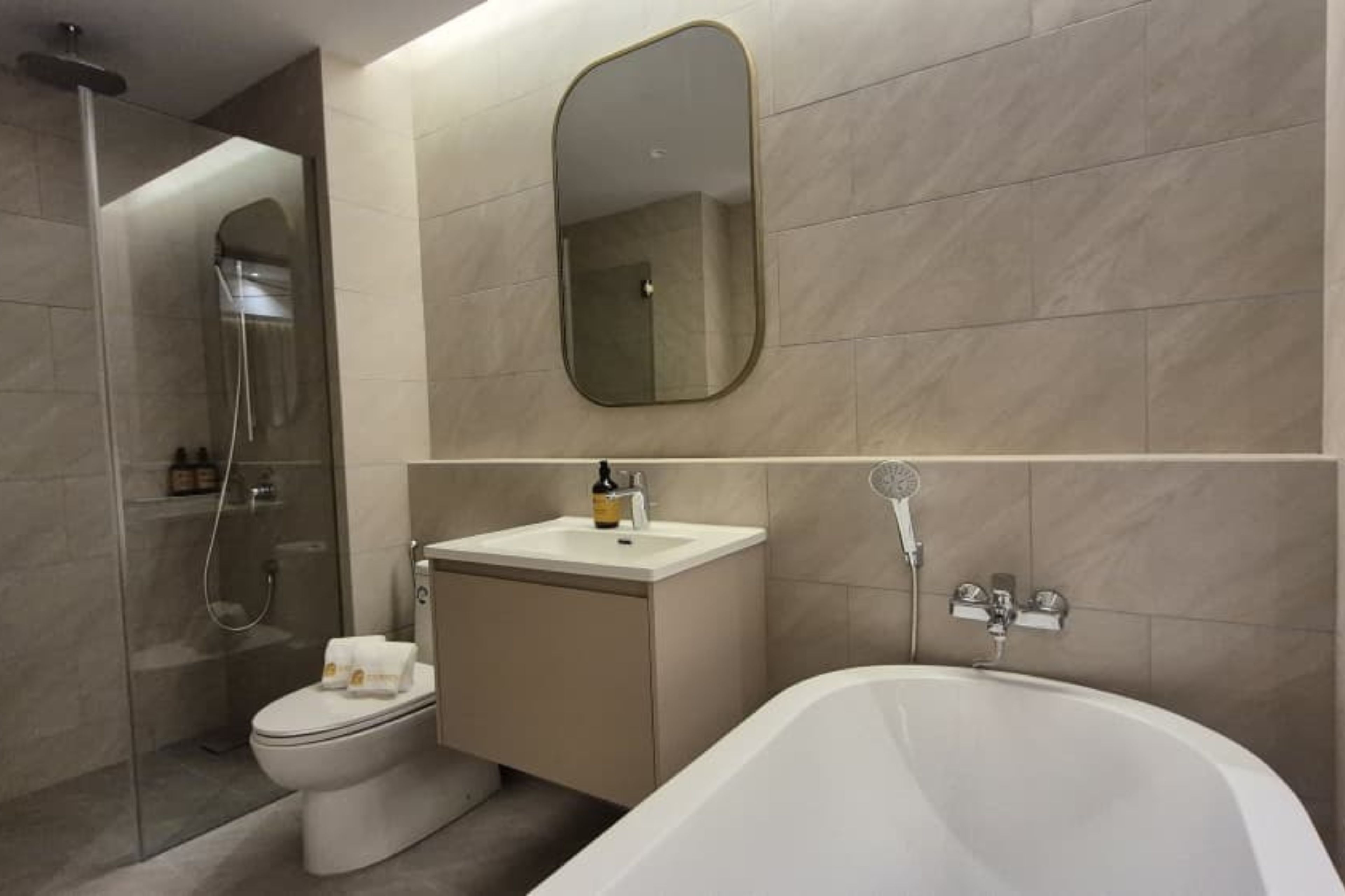 A modern bathroom with a toilet, sink, and bathtub.