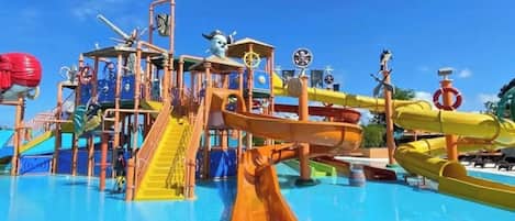 A water park with a large slide and various play structures.