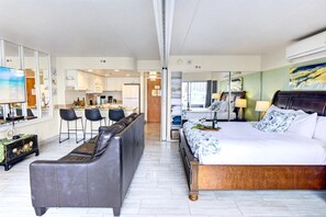 Une chambre d’hôtel comprenant un lit, un canapé, un coin repas et une cuisine.