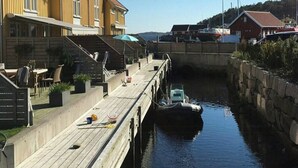 A waterfront property with a dock, wooden buildings, and a canal.