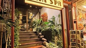 A staircase leading to a spa entrance with a sign reading 'NHÀ SPA'. - Hideout: Romantic Bathtub Escape at Old Quarter (Hà Nội)