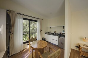 A compact kitchen with a dining area, a built-in oven, and a refrigerator. - Aloe Valley (Ndaragwa)
