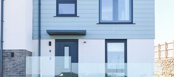 A modern costal Mews House in the scenic Bull Bay, offering stunning coastal views for up to 5 guests