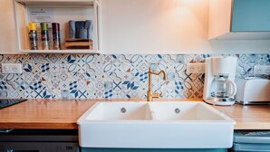 A kitchen with a double sink, a coffee maker, and a toaster. - NEW ACCOMMODATIONS IN A VILLAGE HOUSE (Orschwiller)