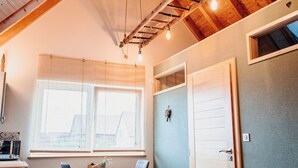 A room with a wooden ceiling, a table with chairs, a window, and a door. - NEW ACCOMMODATIONS IN A VILLAGE HOUSE (Orschwiller)