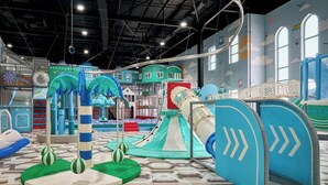 A children's play area with various play structures, slides, and climbing elements. - Arda Karvon Saroy (Khiva)