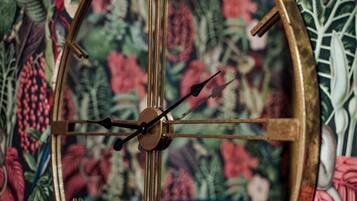 A wall clock with a floral background.