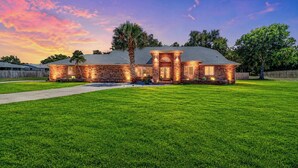 A brick house with a well-maintained lawn and a clear sky. - Resort-Style Estate w/ Heated Pool, Theater & Pickleball (Seminole)