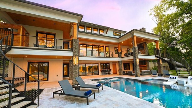 A multi-story house with a swimming pool, outdoor seating, and a staircase. - Willow Landing (Troutman)