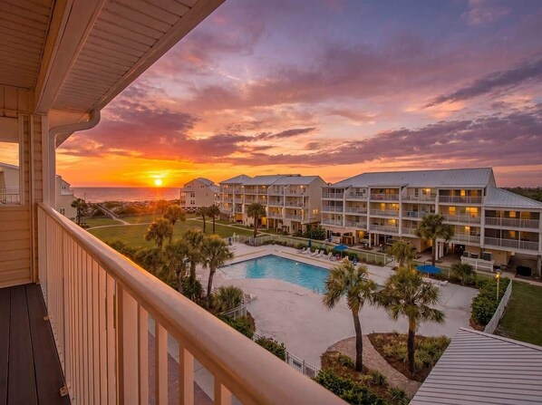 A hotel with multiple floors, a swimming pool, and a sunset view. - High Tides & Good Vibes- Seacliffs-North Cape San Blas (Port St. Joe)