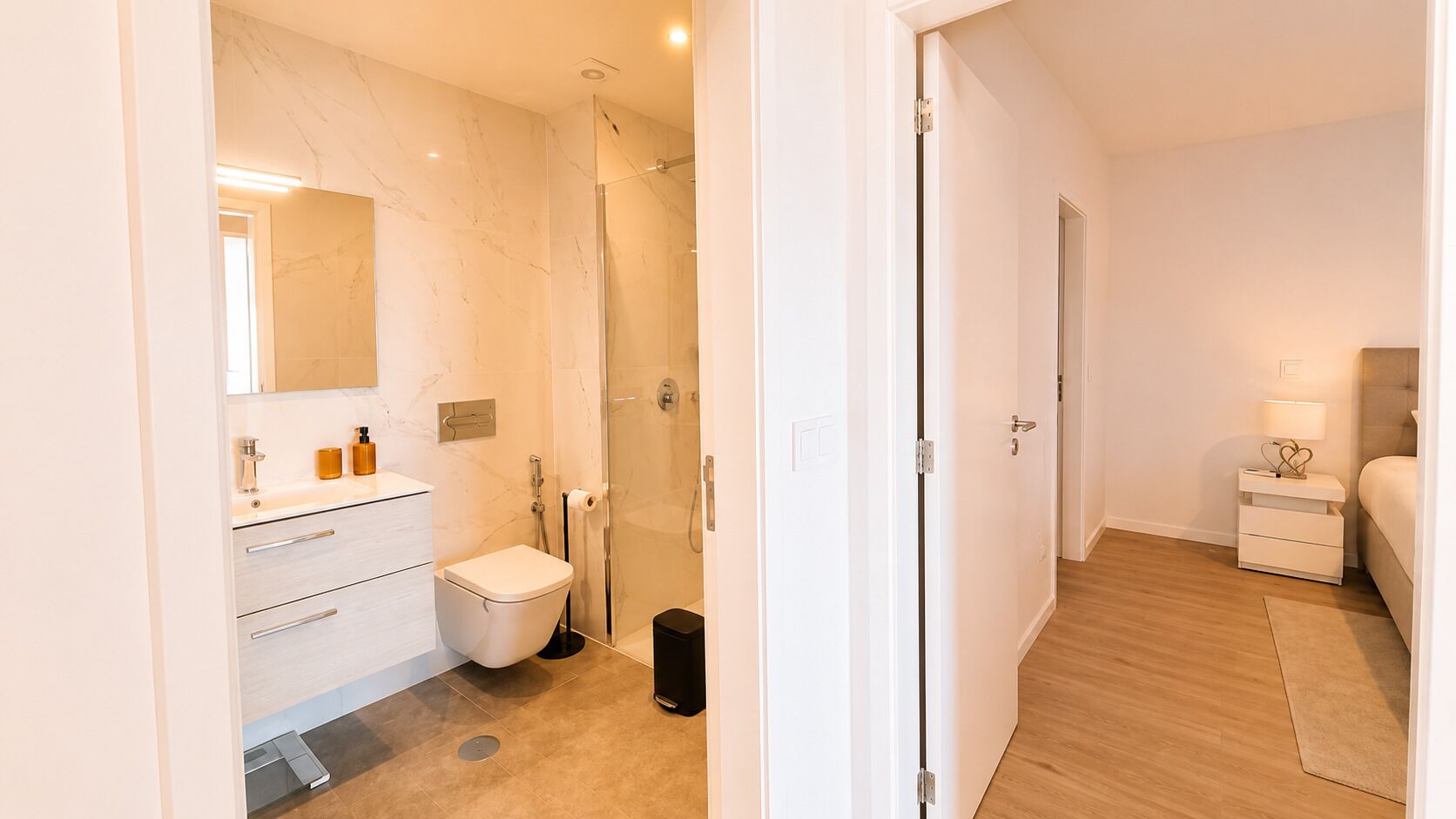 A modern bathroom with a shower, toilet, and sink.