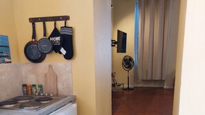 A laundry area with a washing machine, a drying rack, and a fan.