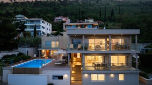 A modern multi-story house with a swimming pool, outdoor seating, and a view of a hilly landscape. - Pedacito de Cielo 1 BDR Sew View apartment & pool (Zagorje)