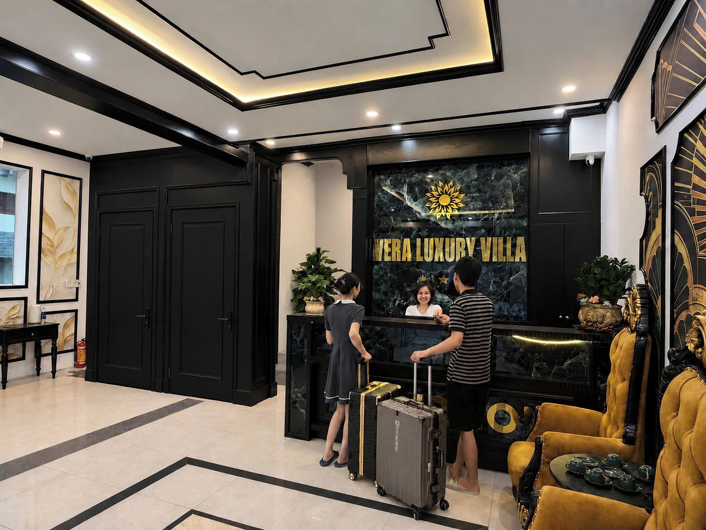 A reception area with a black reception desk, a sign reading 'Vera Luxury Villa,' and a seating area with a sofa and chairs.